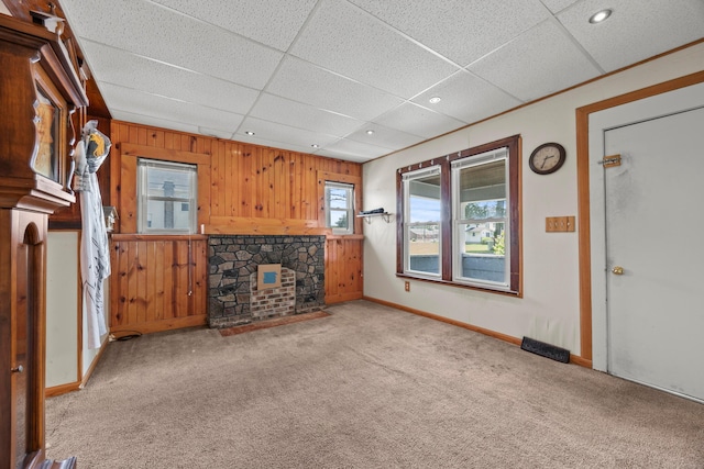 716 Uncapher Ave, Marion, OH 43302 - unfurnished living room featuring carpet floors, wooden walls, a drop ceiling, and recessed lighting