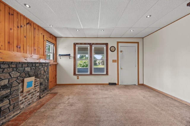716 Uncapher Ave, Marion, OH 43302 - unfurnished living room with carpet flooring, a fireplace, recessed lighting, and wooden walls