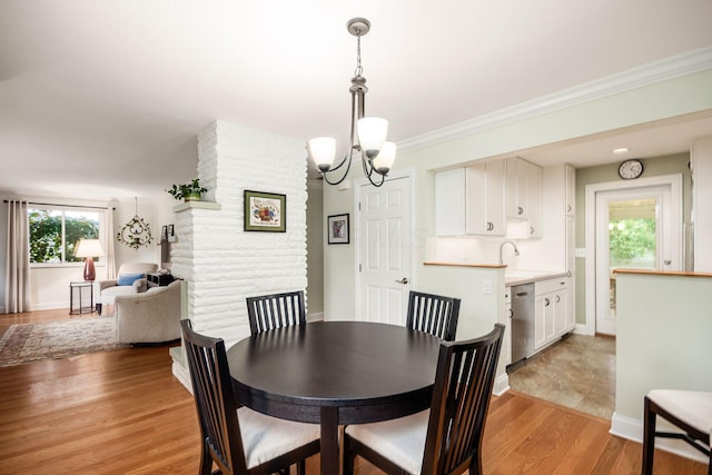 2269 Cranford Rd, Columbus, OH 43221 - dining area featuring a chandelier, light wood finished floors, and ornamental molding