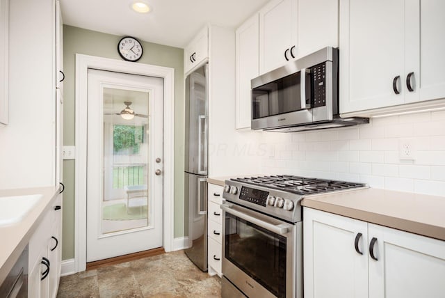 2269 Cranford Rd, Columbus, OH 43221 - kitchen featuring appliances with stainless steel finishes, tasteful backsplash, white cabinets, light countertops, and recessed lighting