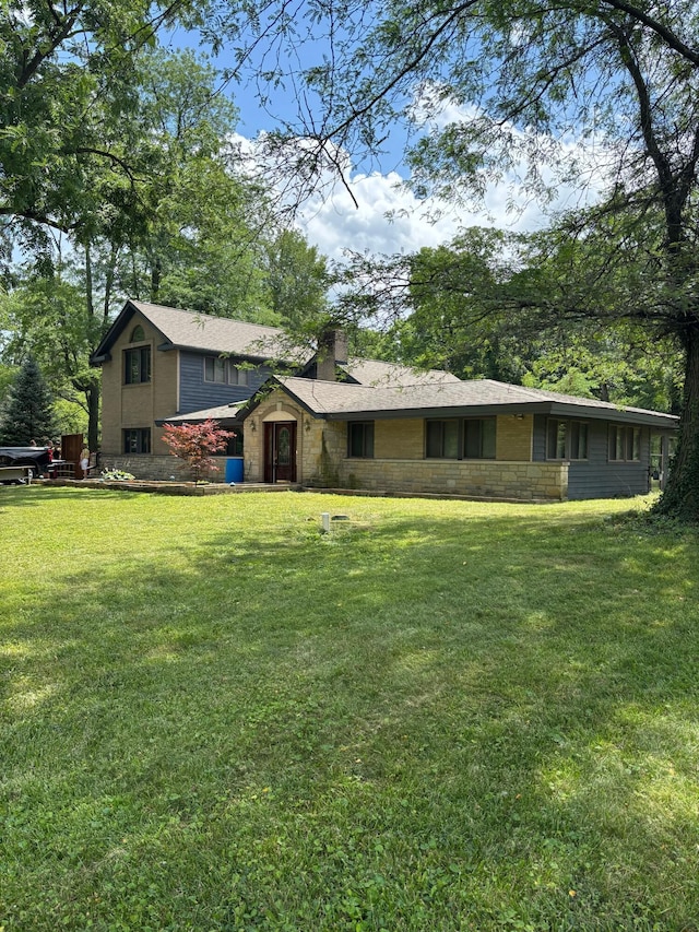 3535 Polley Rd, Columbus, OH 43221 - back of property featuring a chimney, a lawn, and stone siding