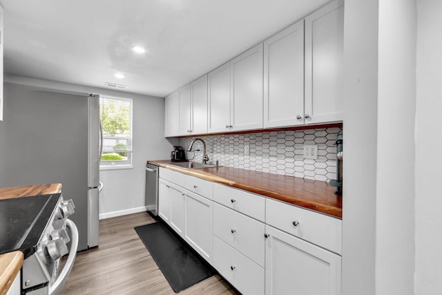 1030 Galliton Ct Unit B, Columbus, OH 43220 - kitchen featuring butcher block counters, stainless steel appliances, light wood-style flooring, decorative backsplash, and recessed lighting