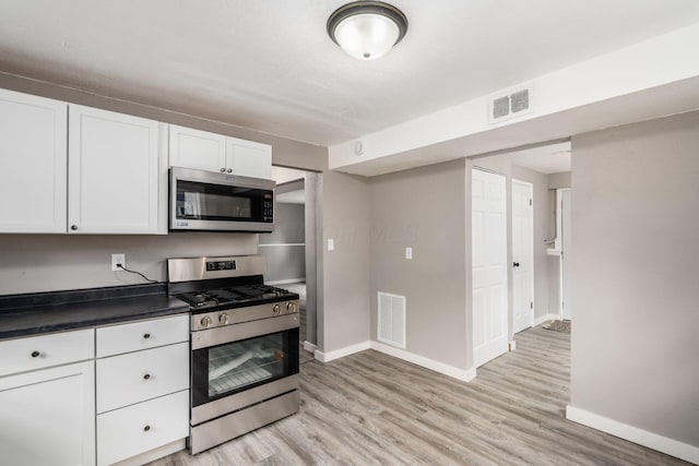 226 N Southampton Ave, Columbus, OH 43204 - kitchen featuring stainless steel appliances, white cabinetry, light wood-style flooring, and dark countertops