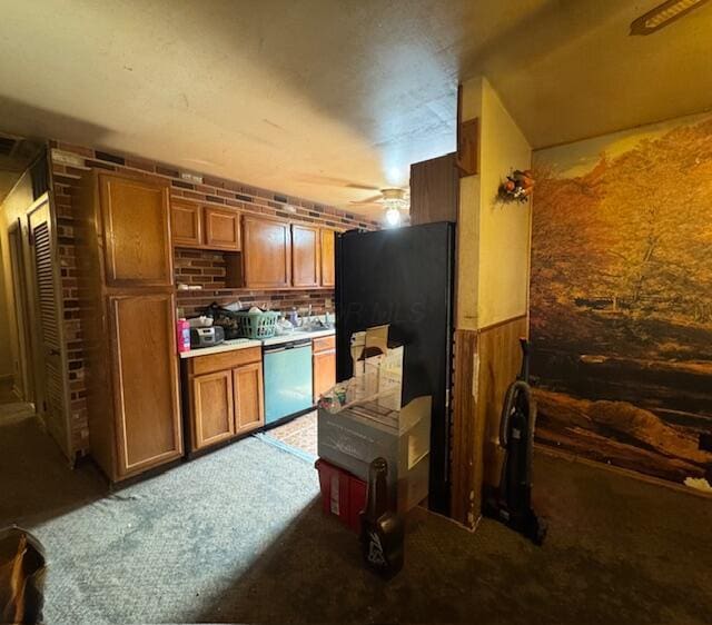 278 Cullman Rd, Columbus, OH 43207 - kitchen with dishwasher, brown cabinetry, ceiling fan, carpet, and freestanding refrigerator