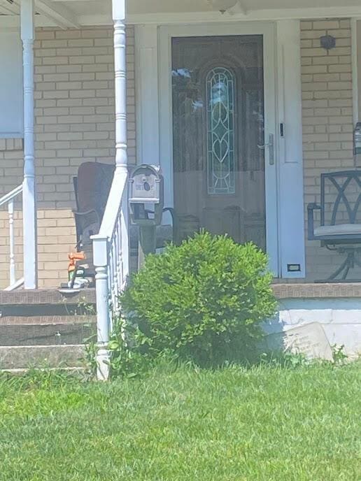 5254 Sedalia Dr, Columbus, OH 43232 - view of exterior entry with a porch and brick siding