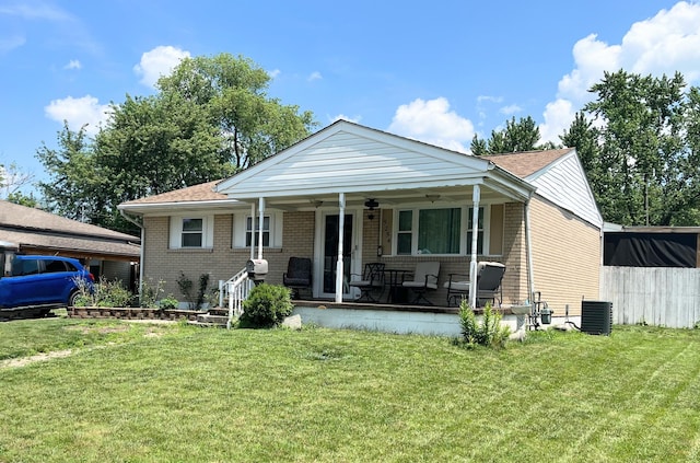 5254 Sedalia Dr, Columbus, OH 43232 - view of front facade featuring ceiling fan, brick siding, a front yard, covered porch, and a shingled roof