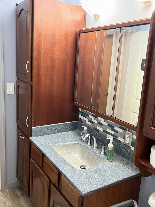 5254 Sedalia Dr, Columbus, OH 43232 - bathroom featuring vanity, wood finished floors, and backsplash