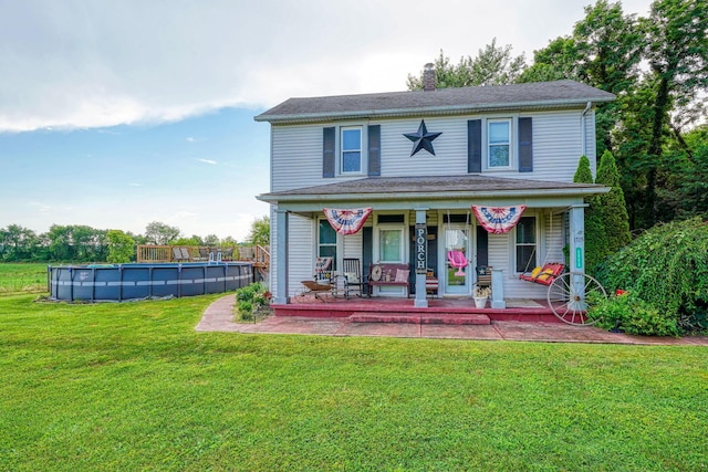 1715 Carroll Southern Rd NW, Carroll, OH 43112 - view of front facade with an outdoor pool, a front yard, covered porch, and a chimney