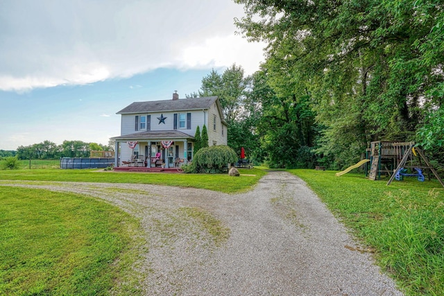 1715 Carroll Southern Rd NW, Carroll, OH 43112 - view of front of house featuring a chimney, a playground, driveway, a front lawn, and covered porch