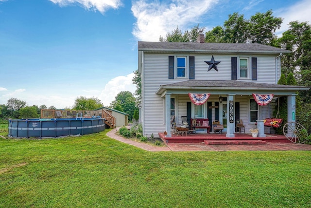 1715 Carroll Southern Rd NW, Carroll, OH 43112 - view of front facade featuring a chimney, a front lawn, covered porch, and an outdoor pool