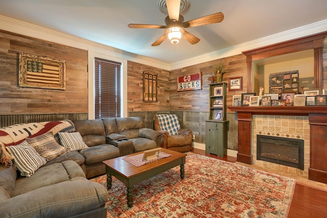 1715 Carroll Southern Rd NW, Carroll, OH 43112 - living room featuring wooden walls, a ceiling fan, crown molding, wood finished floors, and a fireplace