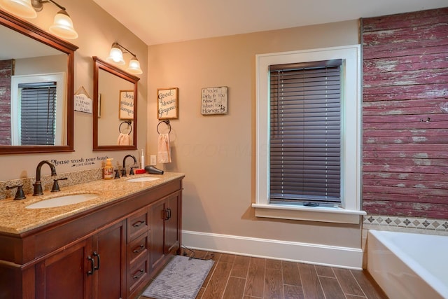 1715 Carroll Southern Rd NW, Carroll, OH 43112 - bathroom with wood finished floors, double vanity, and a tub