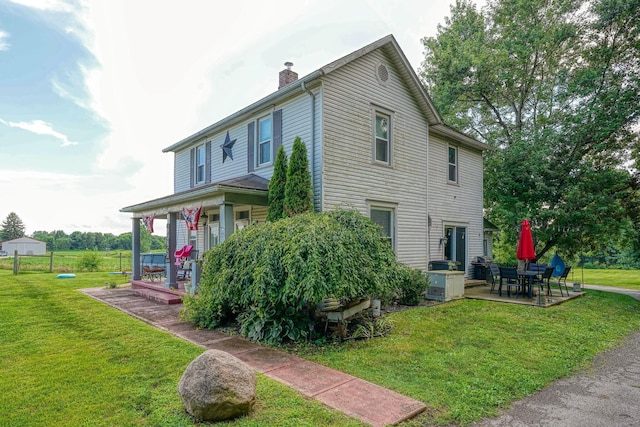 1715 Carroll Southern Rd NW, Carroll, OH 43112 - view of side of property with a chimney, a yard, and a porch