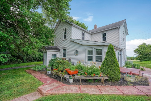 1715 Carroll Southern Rd NW, Carroll, OH 43112 - view of front of house with a chimney, a front yard, and a vegetable garden