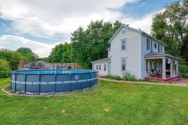 1715 Carroll Southern Rd NW, Carroll, OH 43112 - rear view of house featuring covered porch, a lawn, and an outdoor pool