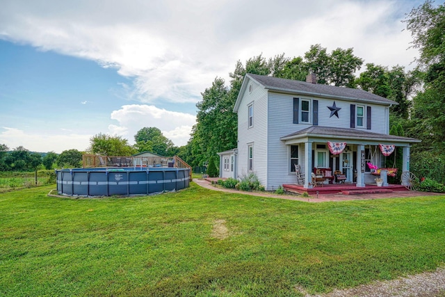 1715 Carroll Southern Rd NW, Carroll, OH 43112 - view of front of home with covered porch, a chimney, a front yard, and an outdoor pool