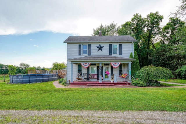 1715 Carroll Southern Rd NW, Carroll, OH 43112 - view of front of house with a porch, a front yard, an outdoor pool, and a chimney