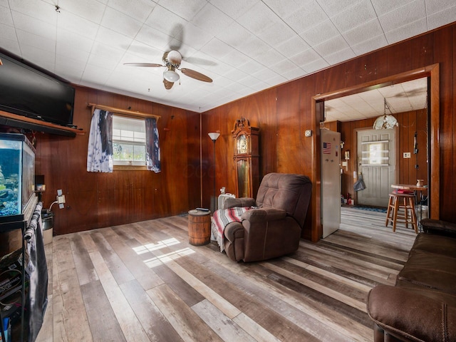 775 Koebel Ave, Columbus, OH 43207 - living room with a ceiling fan, wood walls, and hardwood / wood-style flooring