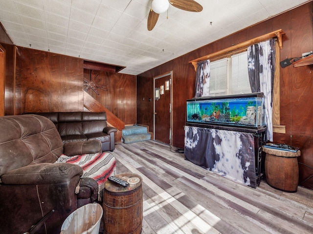 775 Koebel Ave, Columbus, OH 43207 - living area with wooden walls, wood finished floors, a ceiling fan, and stairway