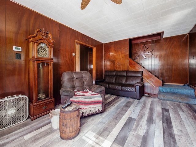 775 Koebel Ave, Columbus, OH 43207 - living room featuring wooden walls, hardwood / wood-style flooring, and a ceiling fan