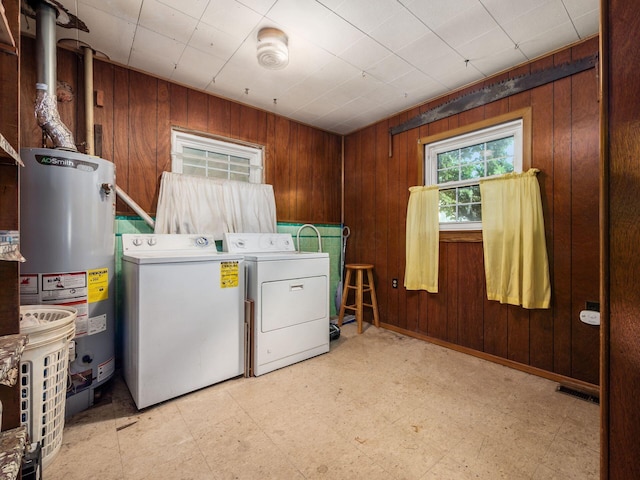 775 Koebel Ave, Columbus, OH 43207 - washroom featuring independent washer and dryer, gas water heater, wood walls, and light floors