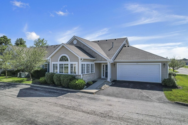 664 Bideford Ave Unit 11B, Blacklick, OH 43004 - view of front of home with an attached garage, asphalt driveway, and roof with shingles