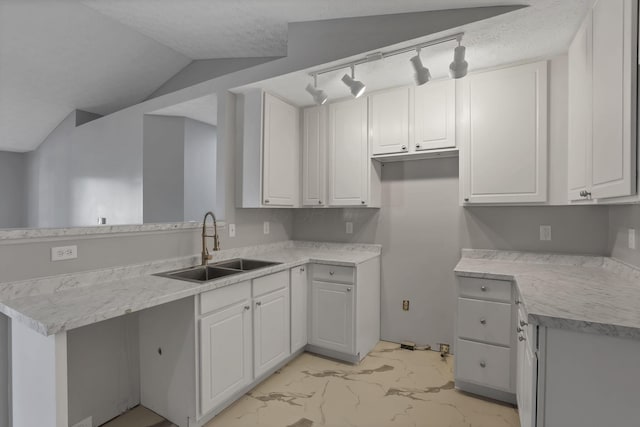 664 Bideford Ave Unit 11B, Blacklick, OH 43004 - kitchen featuring a peninsula, light marble finish floors, white cabinets, light countertops, and a textured ceiling