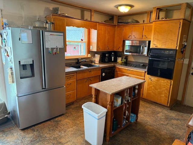 16 Horseshoe Dr, Monroeville, OH 44847 - kitchen featuring black appliances, brown cabinets, light countertops, a center island, and stone finish floors