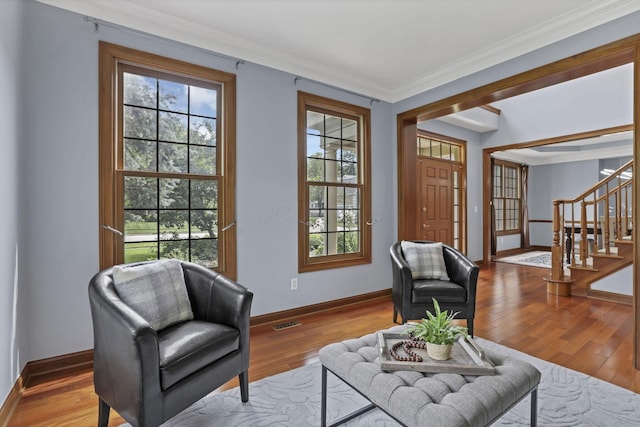 2773 Eleanor Way, Lewis Center, OH 43035 - living room featuring stairway, healthy amount of natural light, crown molding, and wood finished floors