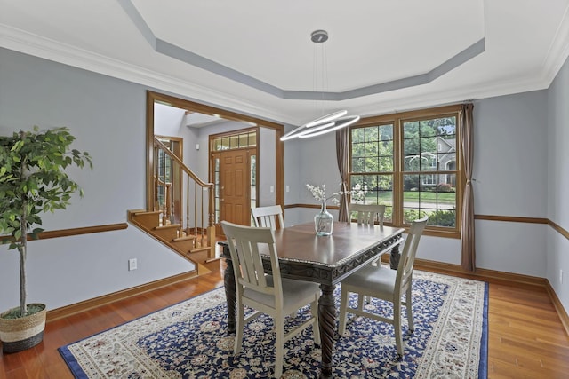 2773 Eleanor Way, Lewis Center, OH 43035 - dining room featuring a tray ceiling, wood finished floors, stairs, and crown molding