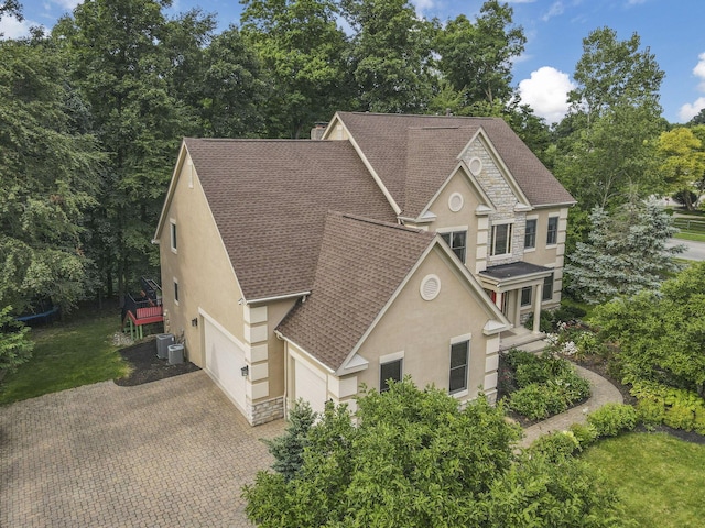 2773 Eleanor Way, Lewis Center, OH 43035 - view of front of property with stucco siding, a shingled roof, decorative driveway, and stone siding