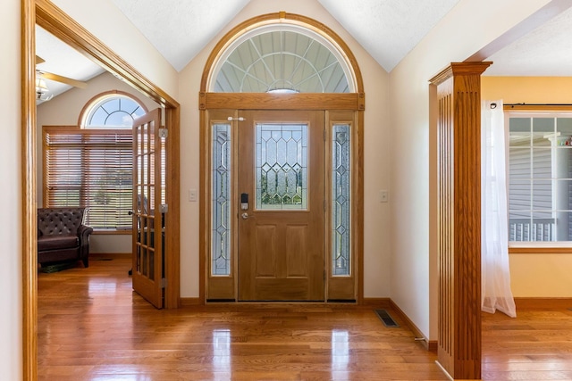 6247 State Route 61, Shelby, OH 44875 - foyer with vaulted ceiling, wood finished floors, healthy amount of natural light, and decorative columns