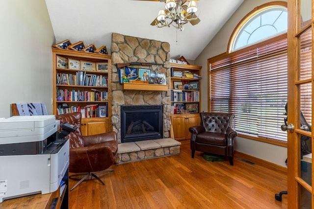 6247 State Route 61, Shelby, OH 44875 - sitting room featuring a ceiling fan, a stone fireplace, wood finished floors, and high vaulted ceiling