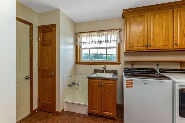 6247 State Route 61, Shelby, OH 44875 - washroom featuring washing machine and clothes dryer, dark tile patterned flooring, and cabinet space
