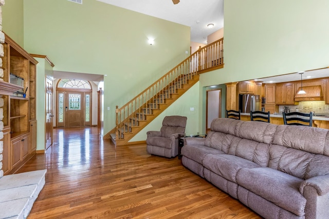 6247 State Route 61, Shelby, OH 44875 - living area featuring a towering ceiling, light wood-style floors, and stairway