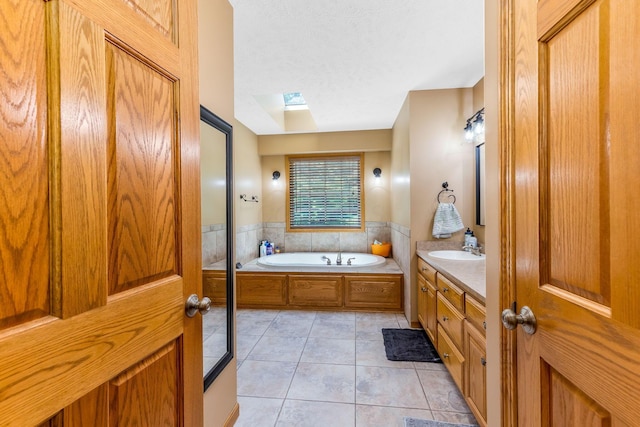 6247 State Route 61, Shelby, OH 44875 - full bathroom with a skylight, tile patterned floors, vanity, a garden tub, and a textured ceiling
