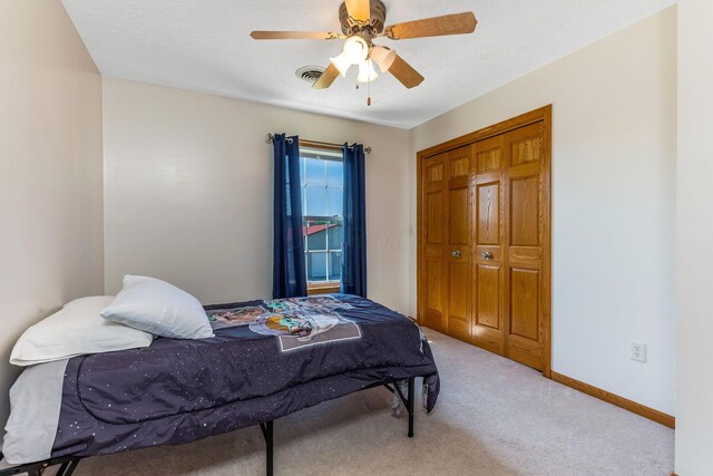 6247 State Route 61, Shelby, OH 44875 - bedroom with light colored carpet, a closet, and ceiling fan