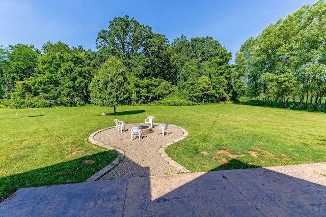 6247 State Route 61, Shelby, OH 44875 - view of grassy yard with an outdoor fire pit and a patio area