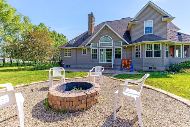 6247 State Route 61, Shelby, OH 44875 - back of property featuring an outdoor fire pit, a lawn, roof with shingles, and a chimney