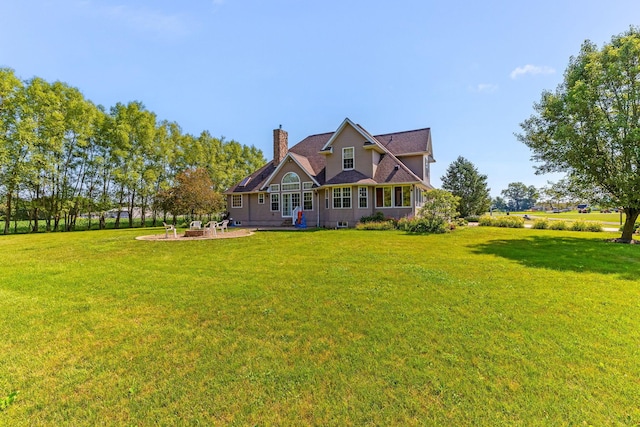 6247 State Route 61, Shelby, OH 44875 - back of house featuring a chimney, a lawn, and a patio area