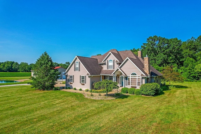 6247 State Route 61, Shelby, OH 44875 - view of front of house featuring a chimney, a front yard, and a water view