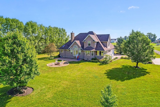 6247 State Route 61, Shelby, OH 44875 - back of property with an outdoor fire pit, a chimney, a yard, and a patio area