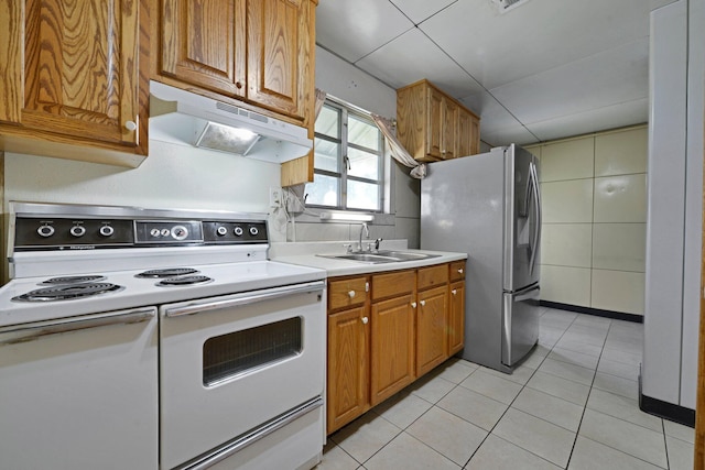 141 Dunmore Rd, Circleville, OH 43113 - kitchen with white range with electric cooktop, under cabinet range hood, stainless steel refrigerator with ice dispenser, light tile patterned flooring, and light countertops