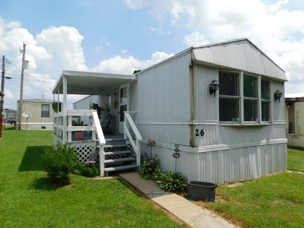 1231 Parkway Dr Lot # 26, Logan, OH 43138 - rear view of property with a lawn and a wooden deck