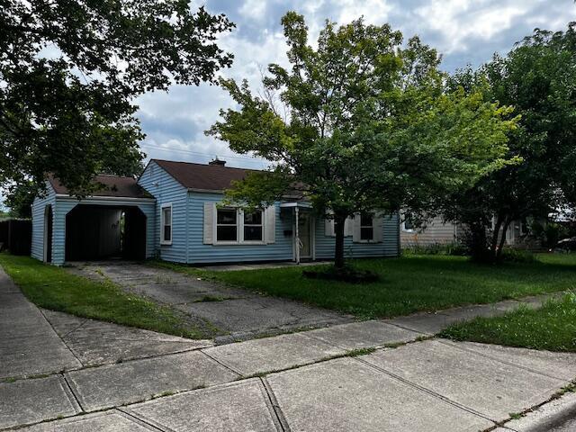 284 Old Village Rd, Columbus, OH 43228 - view of front facade featuring a front lawn, a garage, and asphalt driveway