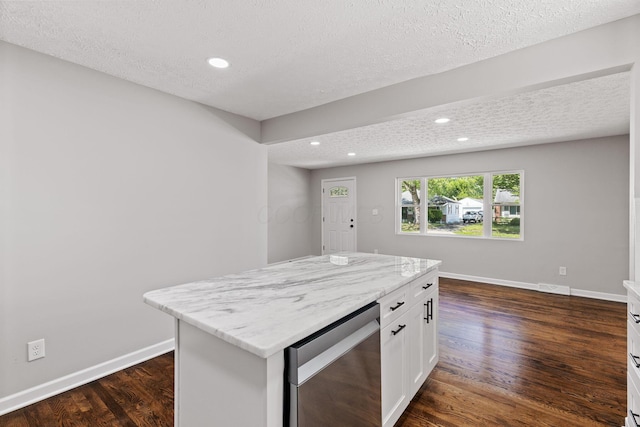4256 Eleanor Ave, Grove City, OH 43123 - kitchen featuring a textured ceiling, white cabinetry, dark wood-style floors, stainless steel dishwasher, and light stone counters