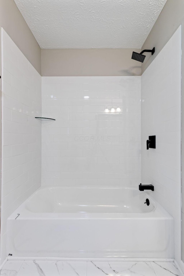 4256 Eleanor Ave, Grove City, OH 43123 - full bathroom with marble look tiles, a textured ceiling, and shower / washtub combination