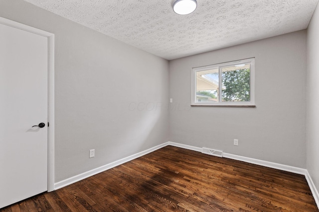 4256 Eleanor Ave, Grove City, OH 43123 - unfurnished room with dark wood-type flooring and a textured ceiling