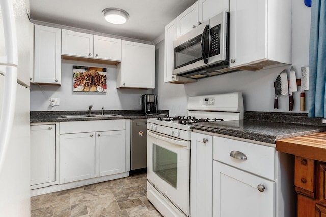 5950 Ambleside Dr, Columbus, OH 43229 - kitchen with stainless steel appliances, white cabinets, and stone finish flooring
