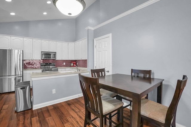 4887 Rays Cir, Dublin, OH 43016 - dining space featuring a towering ceiling, dark wood-style flooring, and recessed lighting